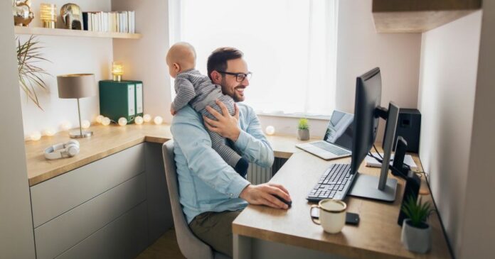 Young,Father,Sitting,In,Front,Of,Computer,Trying,To,Work