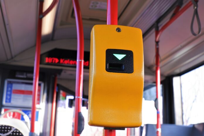 Yellow colour ticket machine automat close up with bus interior background in Budapest, Hungary BKK jegyellenőrző
