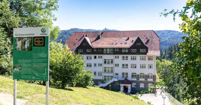 Scenic view of the Black Forest Clinic with an information board in front in Glottertal, Germany
